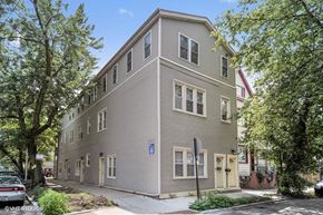 Chicago apartment for rent - a grey apartment building on the corner of a street