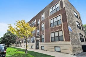 Chicago apartment for rent - a large brick building with a tree in front of it