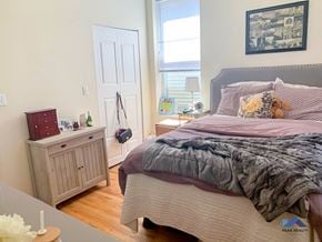 Chicago apartment for rent - a bedroom with a bed and a dresser and a window