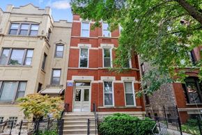 Chicago apartment for rent - a red brick apartment building with a tree in front of it