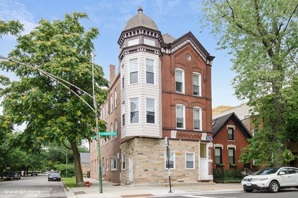 Chicago apartment for rent - a building with a tower on the corner of a street