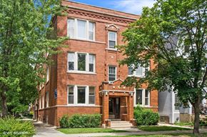 Chicago apartment for rent - a red brick building with trees in front of it