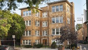 Chicago apartment for rent - a brick apartment building with windows and a gate
