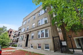 Chicago apartment for rent - A brick building with a black gate in front.