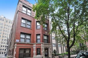 Chicago apartment for rent - a brick building with a tree in front of it