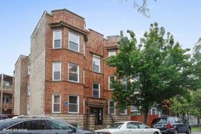 Chicago apartment for rent - a brick building with cars parked in front of it