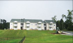Lawrenceville apartment for rent - a large apartment building with a tractor in front of it