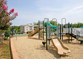 Farmville apartment for rent - a playground with slides and other toys in a park
