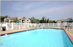 Farmville apartment for rent - a large blue swimming pool with a white fence around it