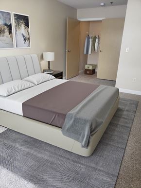 Grand Forks apartment for rent - a bedroom with a bed with a grey blanket on it