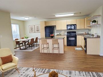 East Grand Forks apartment for rent - a view of a living room and kitchen with a table and chairs