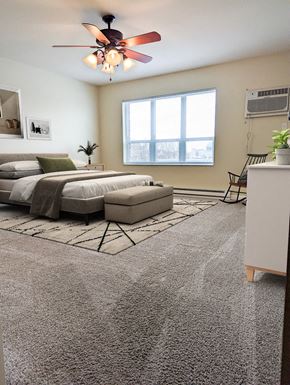 East Grand Forks apartment for rent - a bedroom with a bed and a ceiling fan