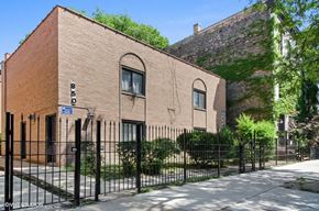 Chicago apartment for rent - a brick building with a fence in front of it