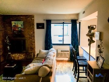 Chicago apartment for rent - a living room with a couch and a fire place