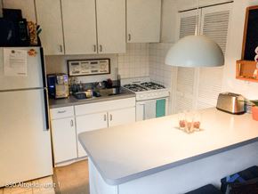 Chicago apartment for rent - a white kitchen with a white table and a white refrigerator