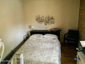Chicago apartment for rent - a small bedroom with a bed and a chair