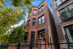 Chicago apartment for rent - a building with a red brick facade and a black fence