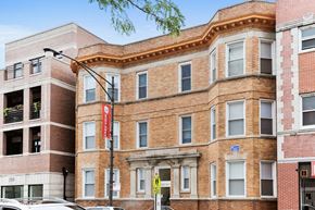 Chicago apartment for rent - a brick building with a red banner on the side of it