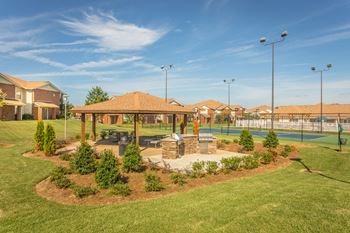 Covered gazebo with picnic tables and charcoal grills