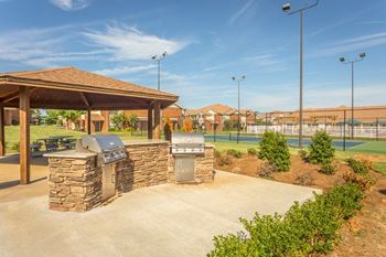 Covered gazebo with picnic tables and charcoal grills