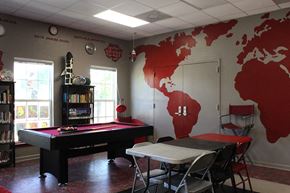 New Orleans apartment for rent - a game room with a pool table and a map of the world on the wall