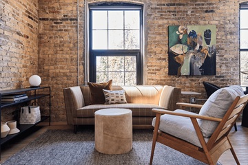 St. Paul apartment for rent - A living room with a brown couch and a painting on the wall.