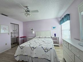 Bradenton house for rent - a bedroom with a bed and a ceiling fan