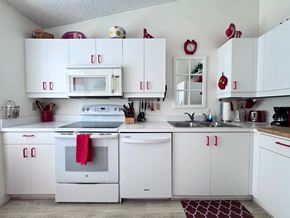 Bradenton house for rent - a white kitchen with white appliances and white cabinets