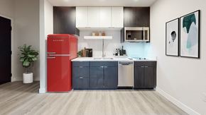 Denver apartment for rent - a kitchen with a red refrigerator and a sink