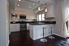 Monterey Park apartment for rent - A kitchen with a black counter top and white cabinets.
