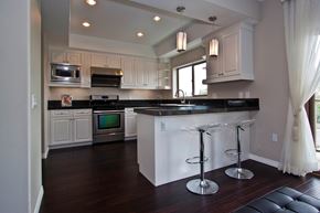 Monterey Park apartment for rent - A kitchen with a black counter top and white cabinets.