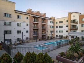 Monterey Park apartment for rent - A large apartment complex with a pool in the courtyard.