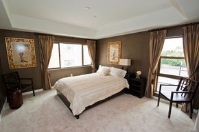 Monterey Park apartment for rent - A bedroom with a large bed and two windows with curtains.