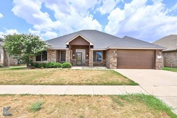 Abilene house for rent - a house with a driveway and a garage door