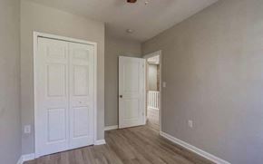 Washington house for rent - A room with a white door and a wooden floor.