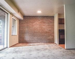 North Versailles apartment for rent - an empty living room with a brick wall