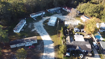 Phenix City apartment for rent - A bird's eye view of a residential area with houses and a swimming pool.