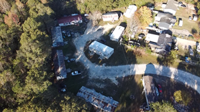 Phenix City apartment for rent - A bird's eye view of a residential area with houses and cars.