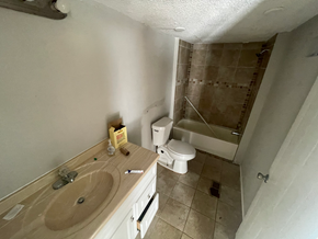 Phenix City apartment for rent - A bathroom with a toilet, sink, and shower.