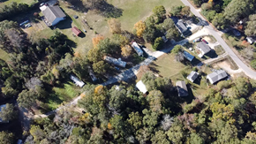 Phenix City apartment for rent - A bird's eye view of a residential area with houses surrounded by trees.