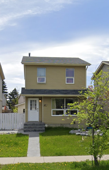 Calgary house for rent - A small house with a white door and a small porch.