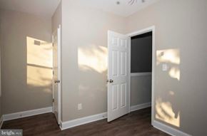 Baltimore house for rent - A room with a white door and a window on the left side.