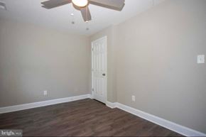 Baltimore house for rent - A room with a white door and a ceiling fan.