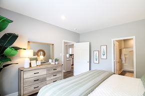 Little Rock house for rent - a bedroom with a bed and a dresser and a bathroom