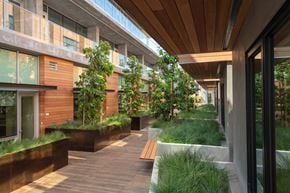 Menlo Ave apartment for rent - A long, narrow walkway with a wooden ceiling and a grassy area on the side.