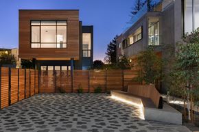 Menlo Ave apartment for rent - A modern house with a wooden fence and a stone patio.
