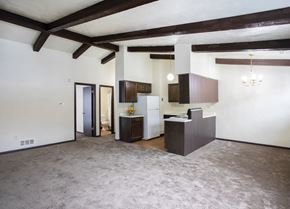 Mckeesport apartment for rent - A spacious living room with a kitchen area in the background.