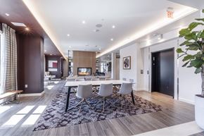 Sacramento apartment for rent - A modern dining room with a fireplace and a large rug.