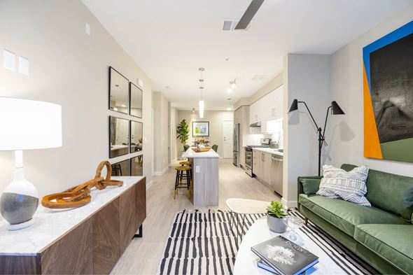 Sacramento apartment for rent - A modern living room with a green couch and a coffee table.