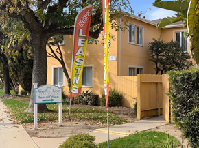 Harbor City apartment for rent - A leasing sign is displayed in front of a house.